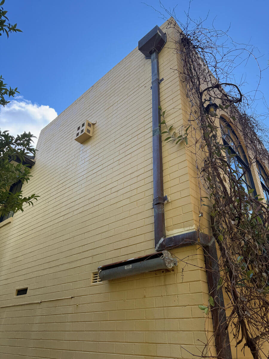Cream rendered exterior wall, soft wash, after